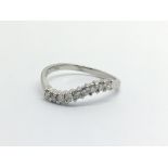 An 18ct white gold nine stone diamond ring, approx .20ct, approx 2g and approx size L.