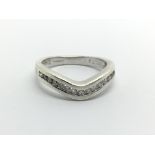 A 9ct white gold half eternity wishbone ring, approx .25ct, approx 3.6g and approx size L.