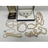 A collection of pearl necklaces, earrings etc.