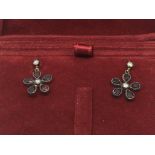 A boxed pair of daisy style earrings set with garn