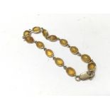 A 9ct gold and amber bracelet. Approx 7.5g.