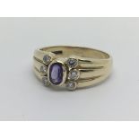 A 9carat gold ring set with amethyst And flanked by six diamond ring size P-Q