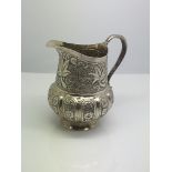 A small Indian silver jug, approx height 8cm.