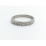 An unmarked white gold eing set with seven small diamonds, aporox .25ct, approx 3.3g and approx size
