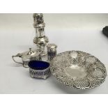 A silver pierced dish a set of condiments and a si