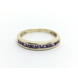 A 9ct gold half eternity ring set with amethyst, approx 1.8g and approx size N-O.