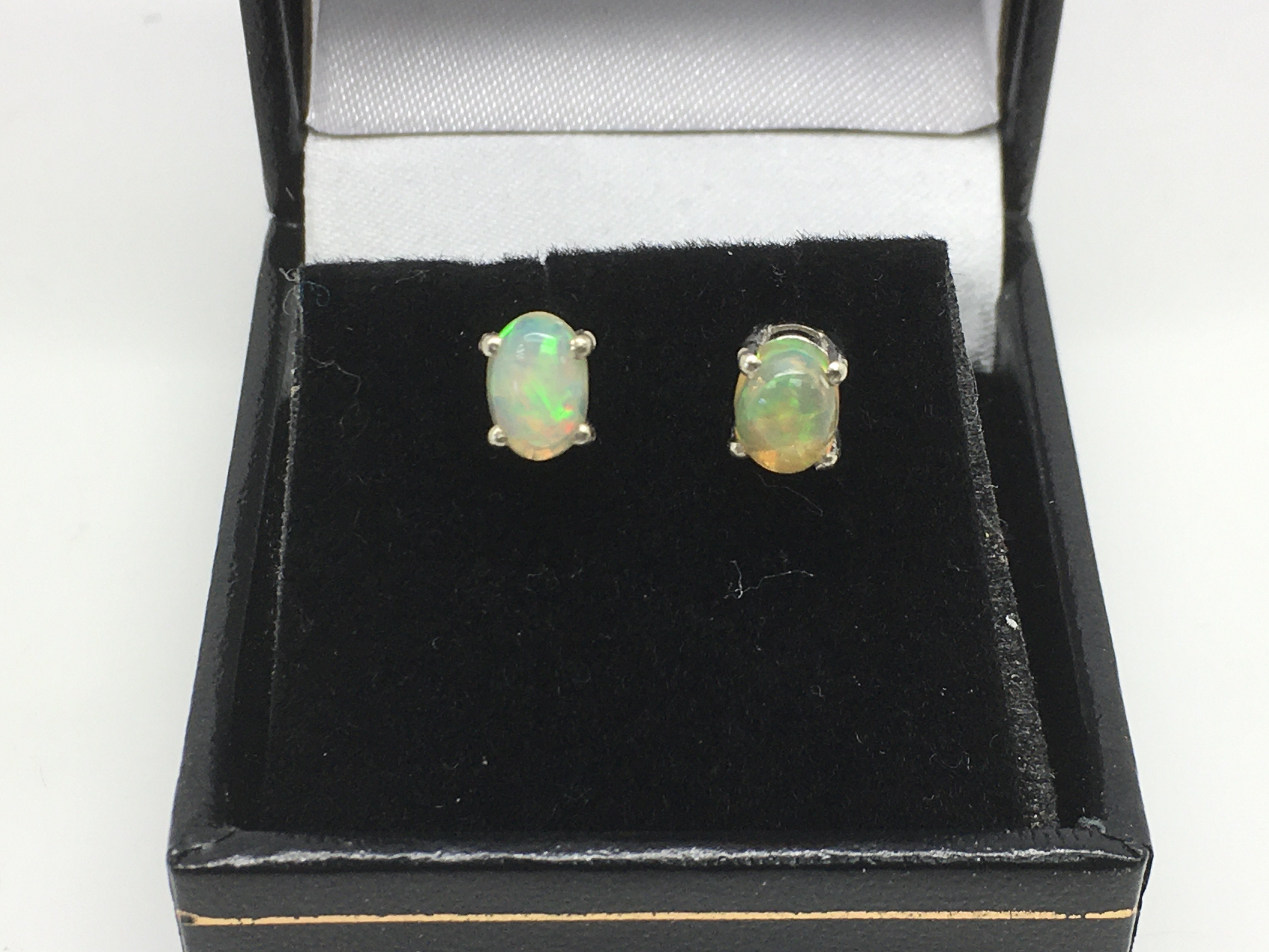 A boxed pair of white Ethiopian opal ear studs set