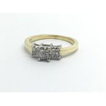 An 18ct gold ring set with twelve princess cut diamonds, approx .25ct, approx 3.1g and approx size