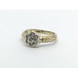 A 9carat gold ring set with a floral pattern of diamonds. 0.25 of a carat approximately. ring size
