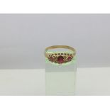 A yellow metal ring set with rubies, approx 2.8g a