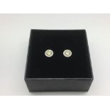 A boxed pair of 18ct white gold fancy yellow diamo