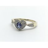 A 9carat gold ring of heart shape set with a tanzanite and small diamonds ring size R.