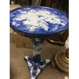 A delft blue and white jardiniere stand / table Decorated with traditional Dutch scenes .