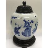 A blue and white ginger jar decorated with figures