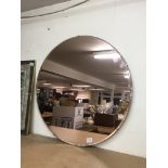 A large 1930s peach glass circular mirror, 76cm di