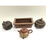 A terracotta planter and three teapots (4).