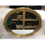A gilt framed oval wall mirror, approx width 69cm.