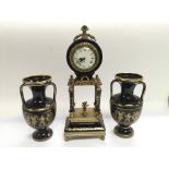 An 8 day porcelain clock garniture in blue and gil