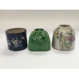 Three ceramic brush pots, two painted with flowers