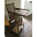 A vintage folding wooden high chair.