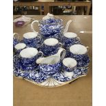 A royal crown derby tea set with matching tray .