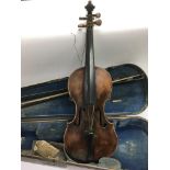 Two antique unmarked violins with bows and cases.