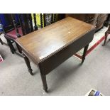 An Early Victorian mahogany Pembroke table with a