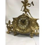 A Victorian style gilt mantel clock with Roman numerals.