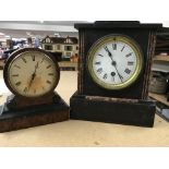 A slate mantel clock and a walnut clock .