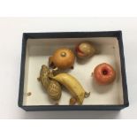 A collection of miniature Japanese ivory fruit.