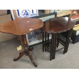 A Victorian walnut occasional table with a shaped top and turned column and a nest of three mahogany