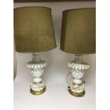 A pair of white glazed ceramic lamps with gilt woo