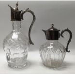 2 silver plated topped and cut glass claret jugs.