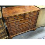 A Yew wood and cross banded chest of drawers with