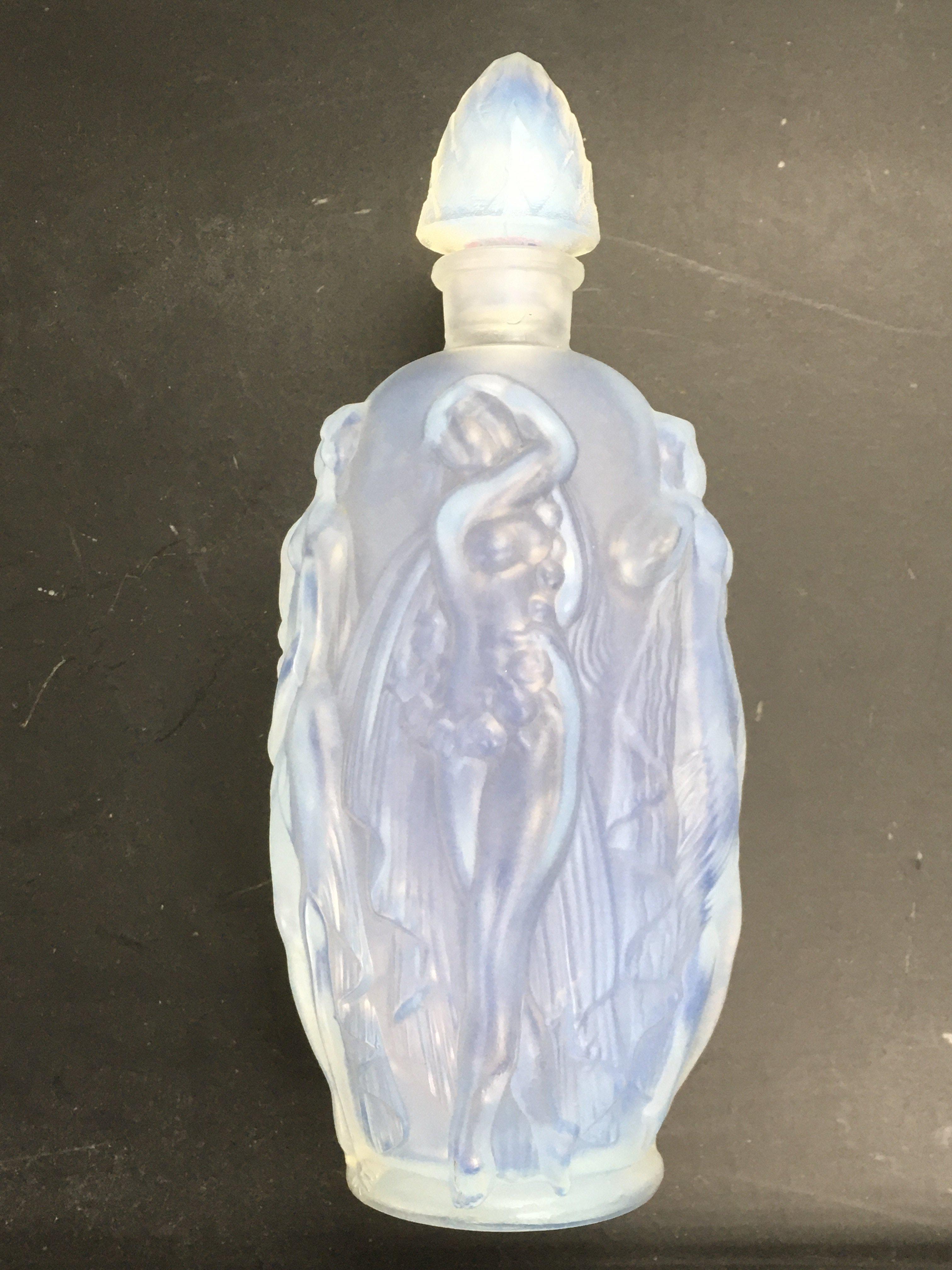 A Sabino perfume bottle decorated with scantily cl