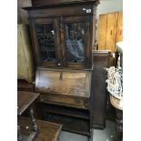 A small arts and crafts oak bureau bookcase with l