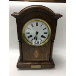 A 1930s oak mantle clock with Junghans movement.