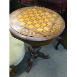 A Victorian walnut trumpet work box with games top