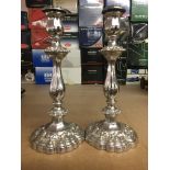 A pair of silver plated candle sticks of Victorian style.