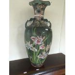 A large satsuma vase decorated with flowers and foliage.