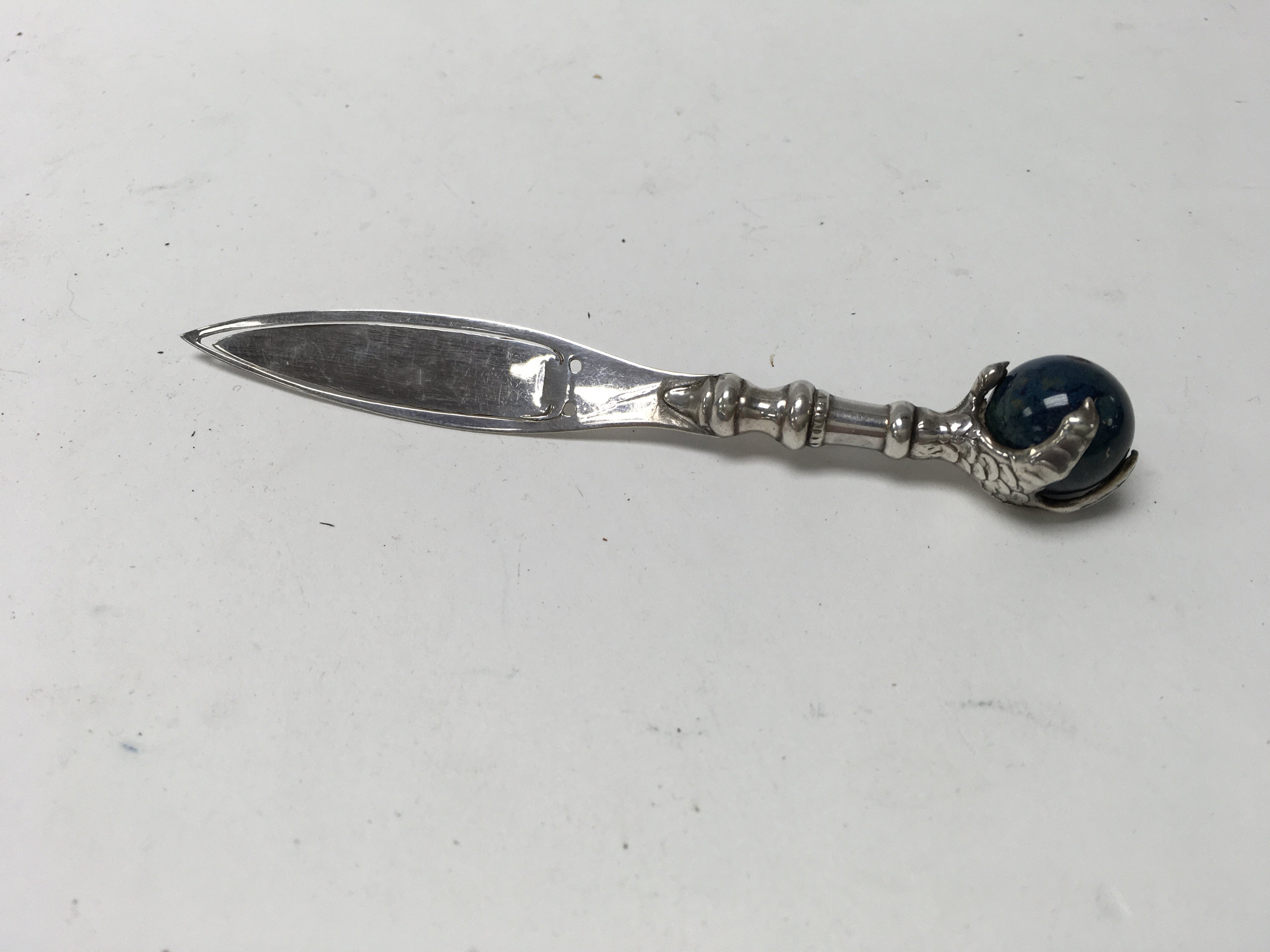 A small silver and lapis lazuli eagles claw design