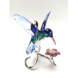 A swarovski diamond in the shape of a humming bird