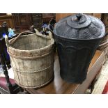 A wooden well bucket with iron hoops and iron hand