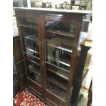 A Edwardian mahogany two door book case with fitted selfs on a plinth base .