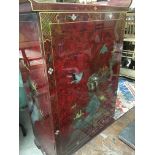 A reproduction oriental style cabinet decorated wi