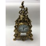 A Mappin & Webb ornate brass mantle clock. (No pen
