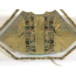 A framed Oriental embroidered jacket.