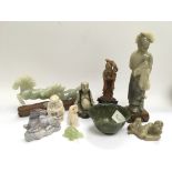 A collection of soapstone items including buddhas