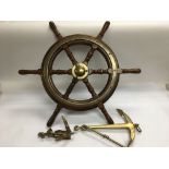 A wooden and brass ship's wheel, ornamental brass