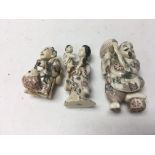 Three Japanese netsuke in the form of a fisherman, god of wisdom and mother and child .